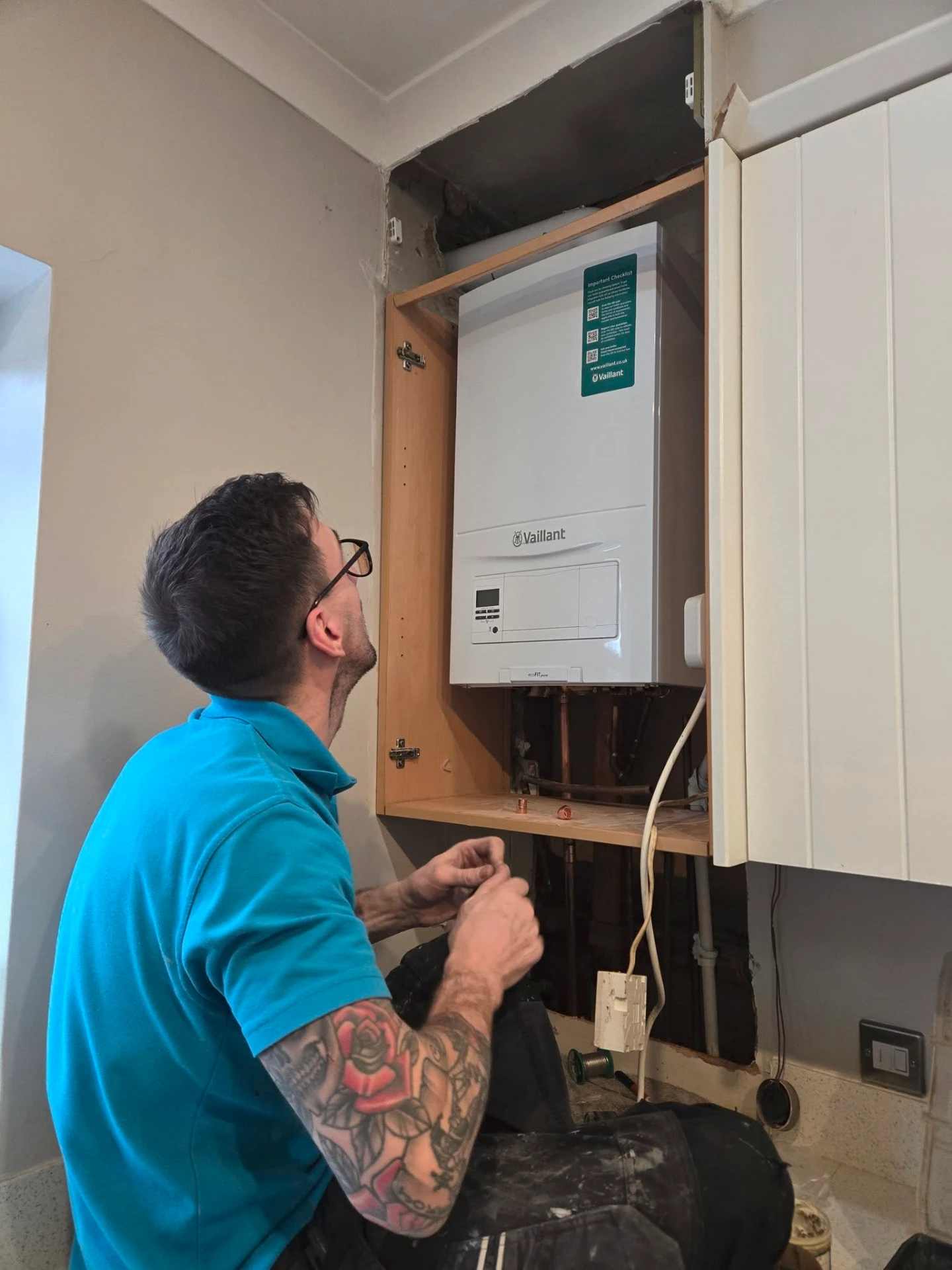 Penylan engineer fitting a new Vaillant boiler in a customer's kitchen