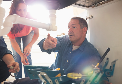 Penylan plumber explaining the work to a customer
